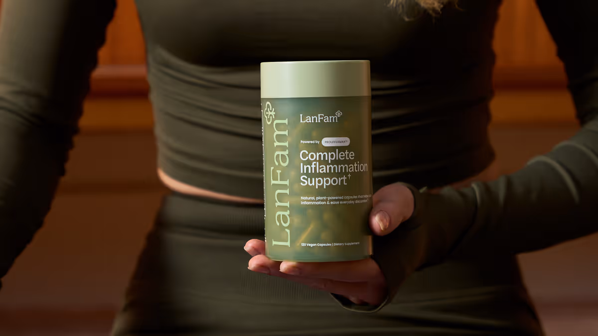 A person in an olive top holding a ProleevaMax jar at their waist